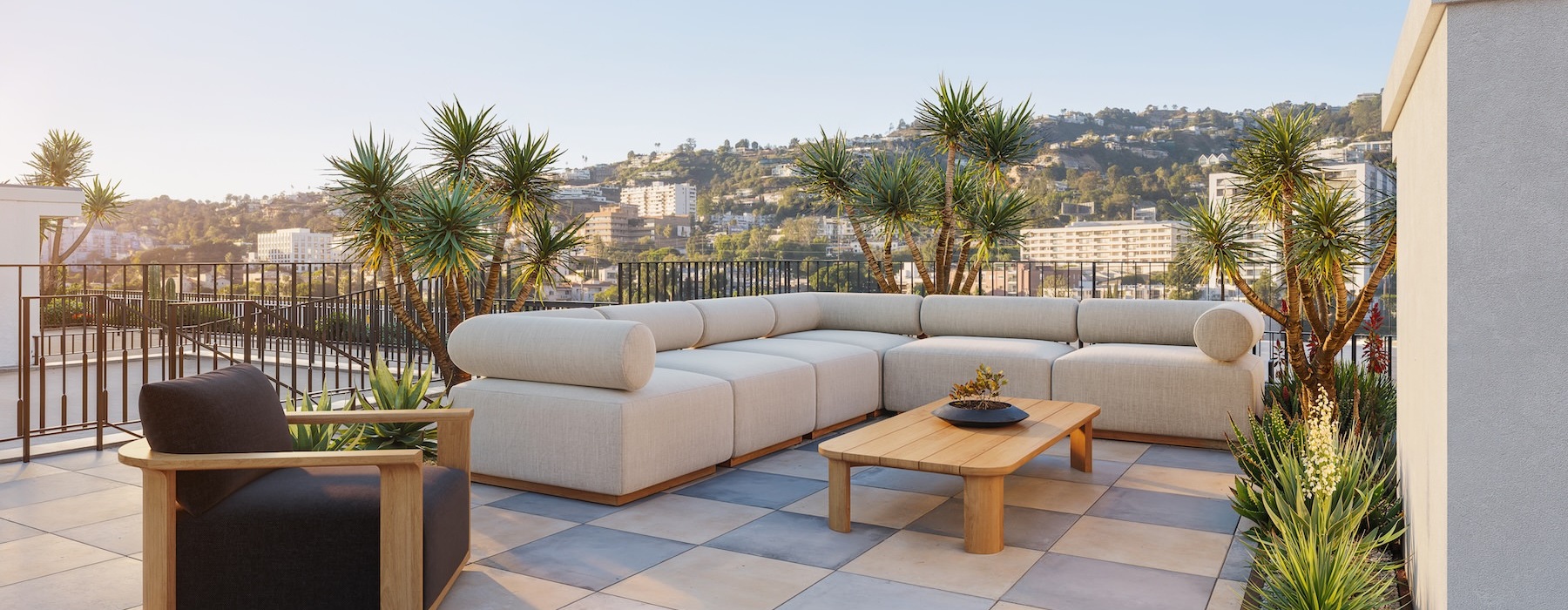 a patio with a large couch, table and chair