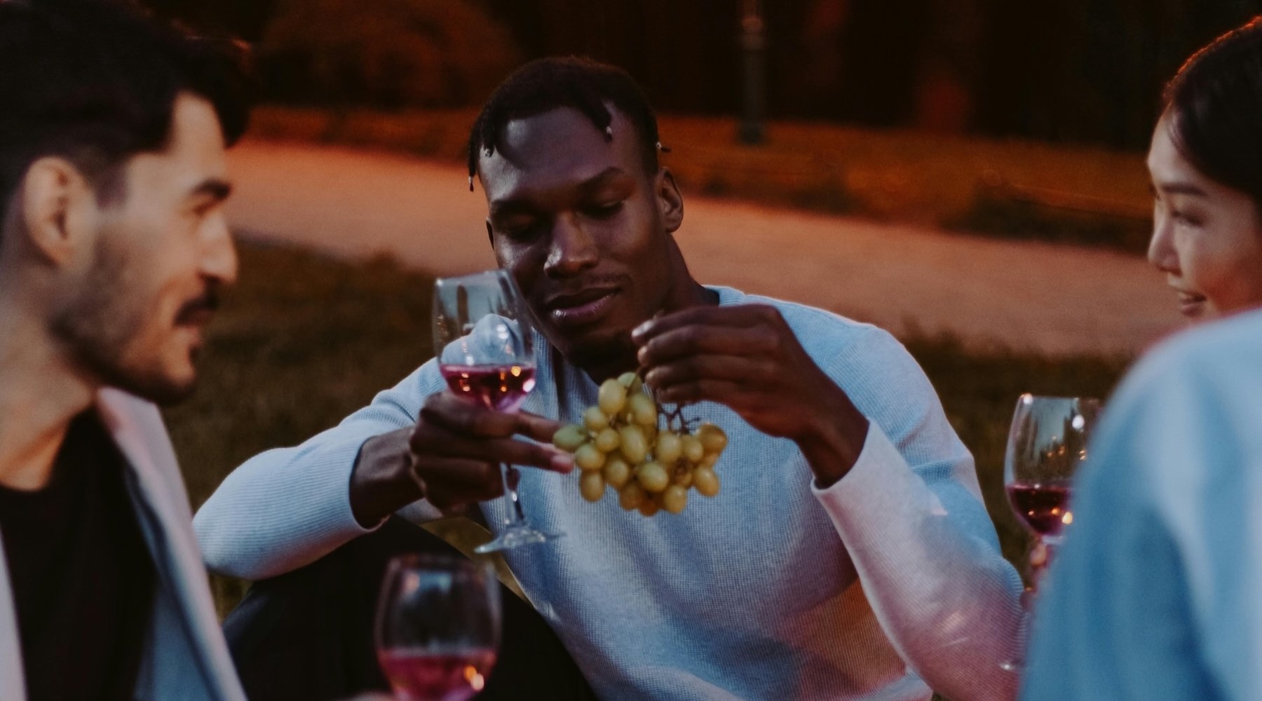 a group of people having a  picnic outdoors